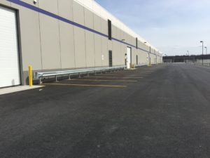 Here is guide-rail installed along the length of a shipping facility. 