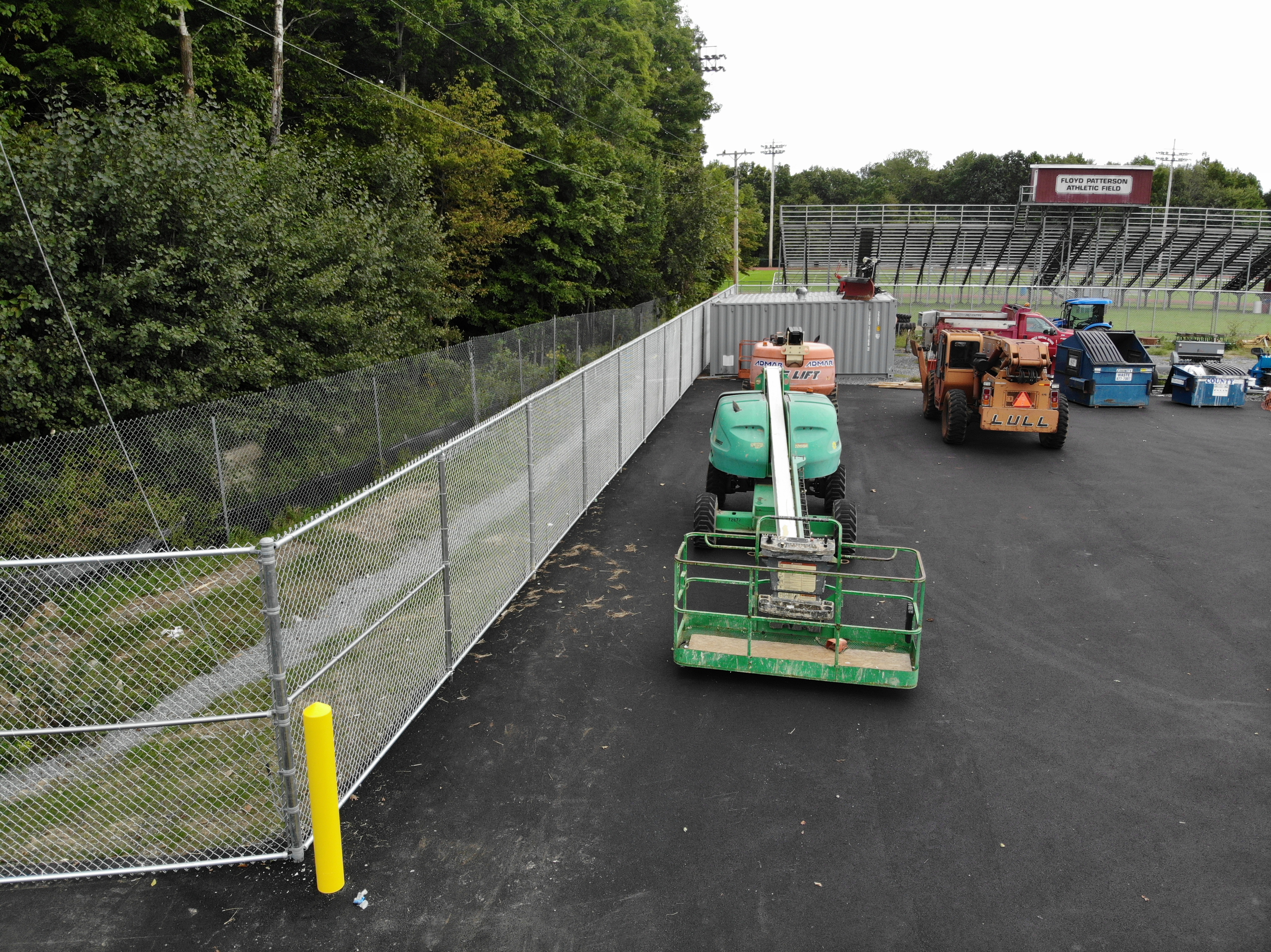 View along side chanlink fence at bus garage