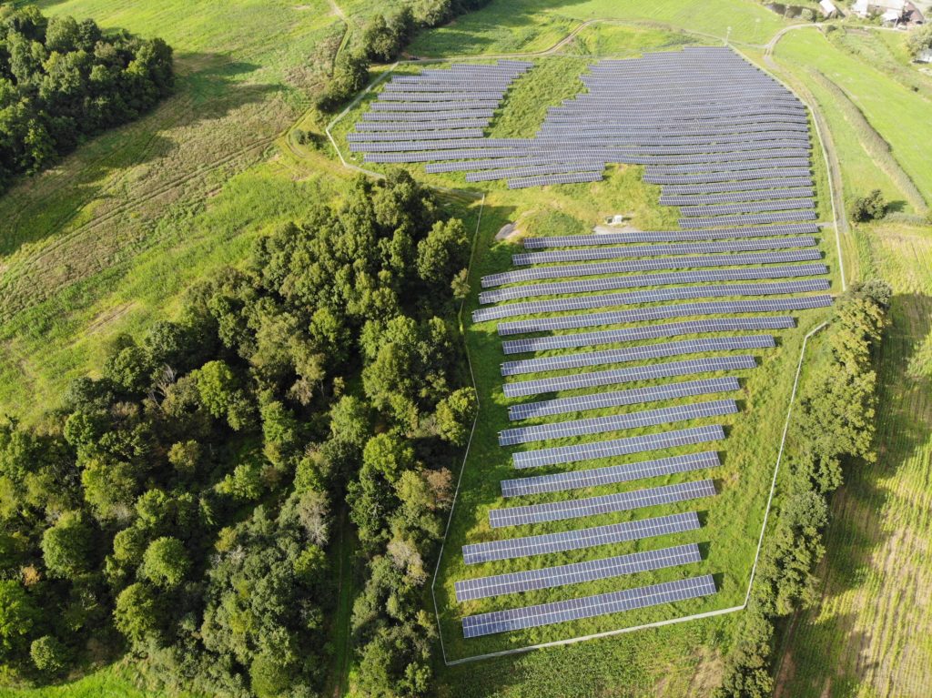 Entire view of solar farm with fence around it