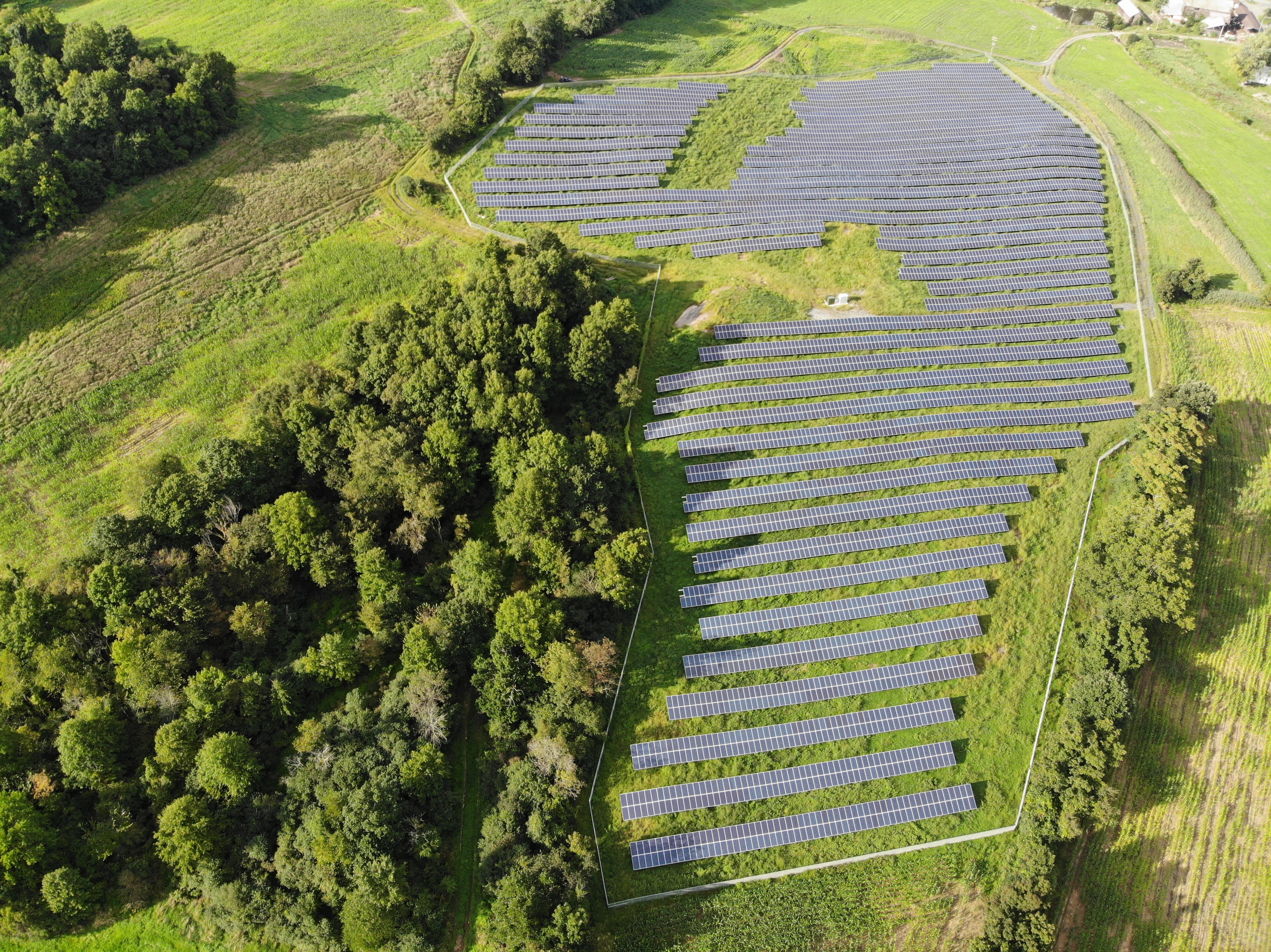 Entire view of solar farm with fence around it