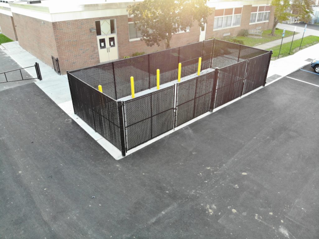 Aerial View of black dumpster enclosure