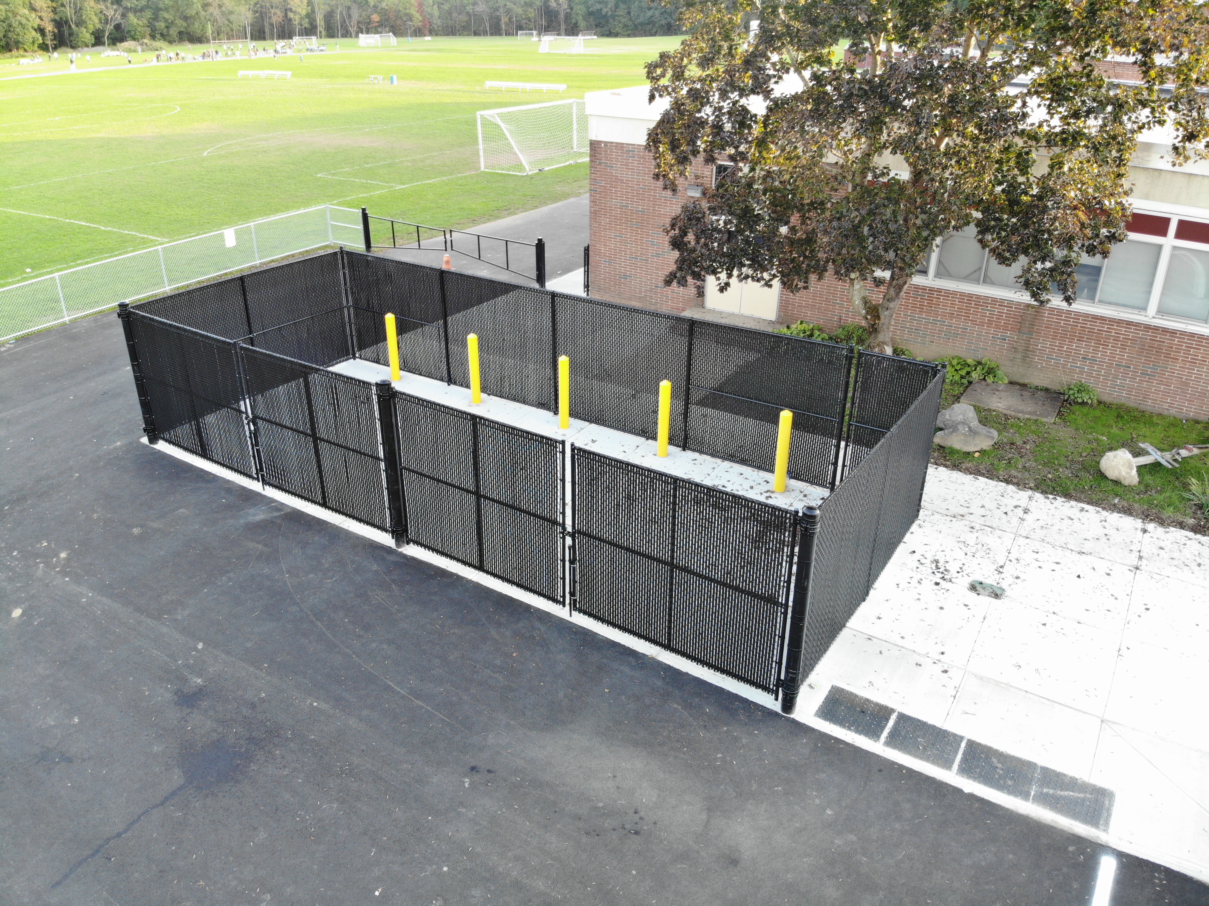 Aerial View of black dumpster enclosure