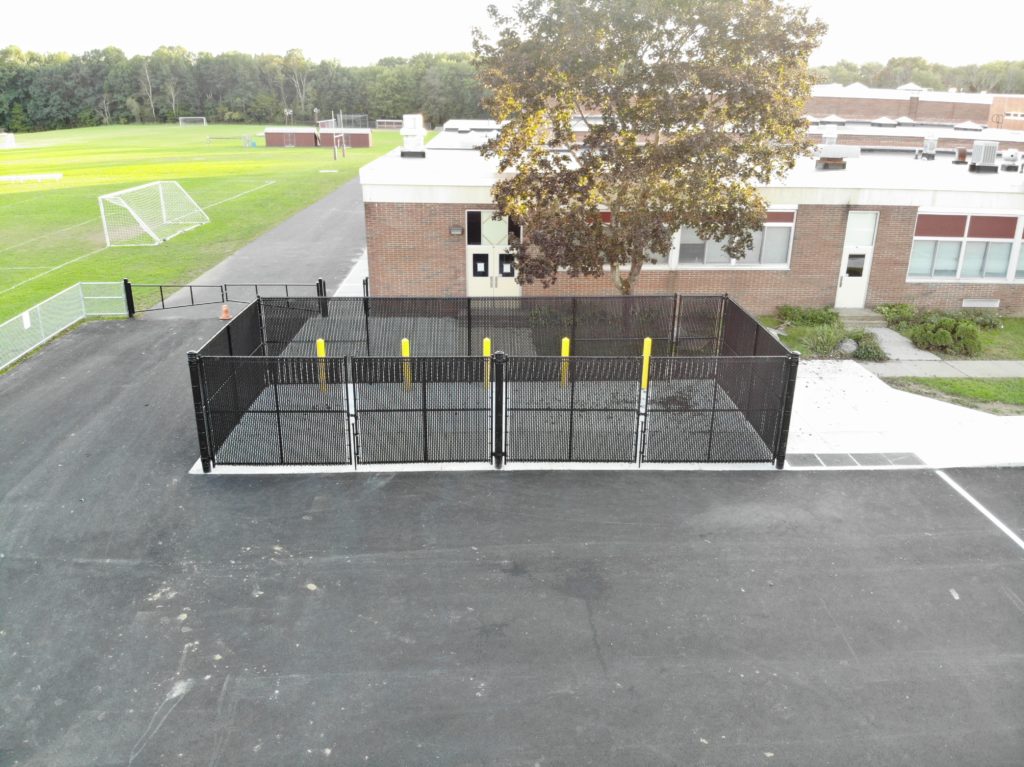Aerial view of black dumpster enclosure