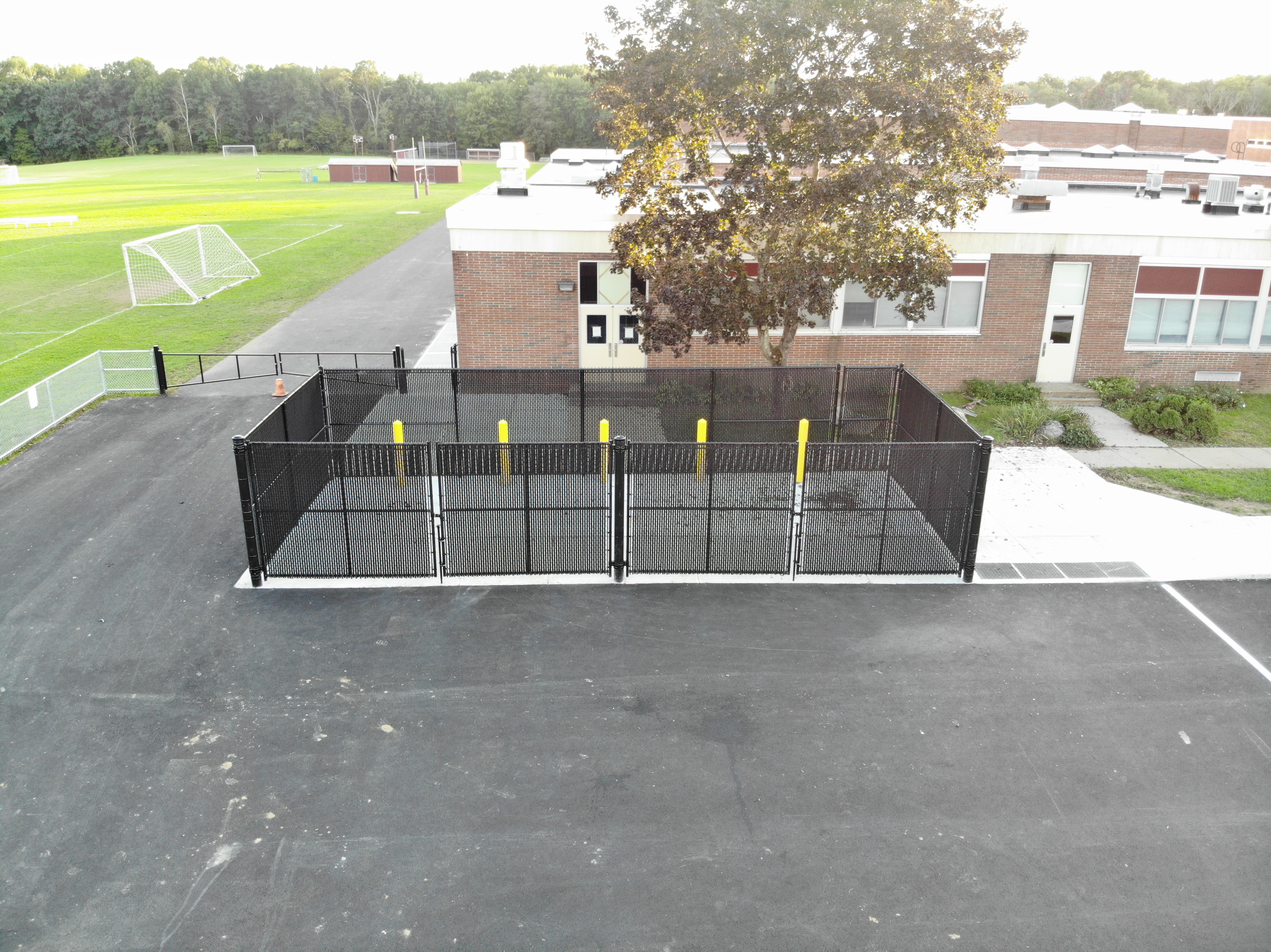 Aerial view of black dumpster enclosure