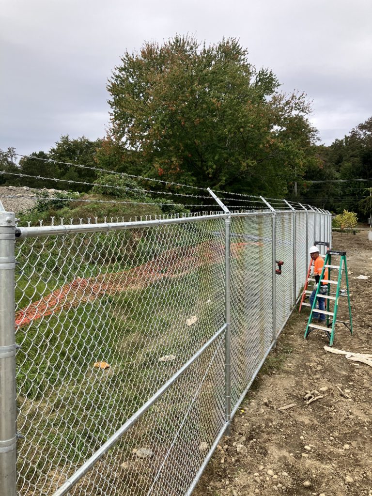 Chainlink fence with barbed wire
